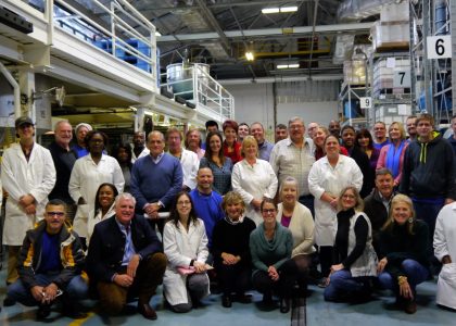 Group photo of employees in a factory.